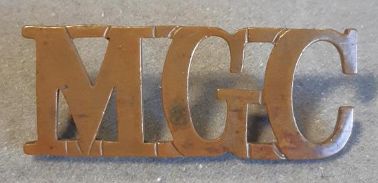 BRITISH Shoulder Title “M.G.C” (Machine Gun Corps) - Gilding Metal